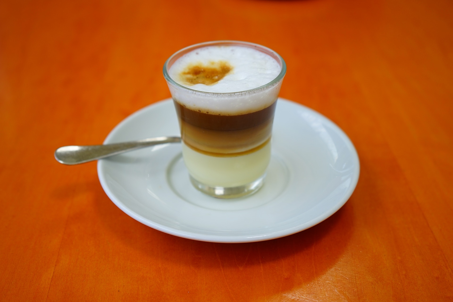 Alternative dairy espresso drink served on a plate.