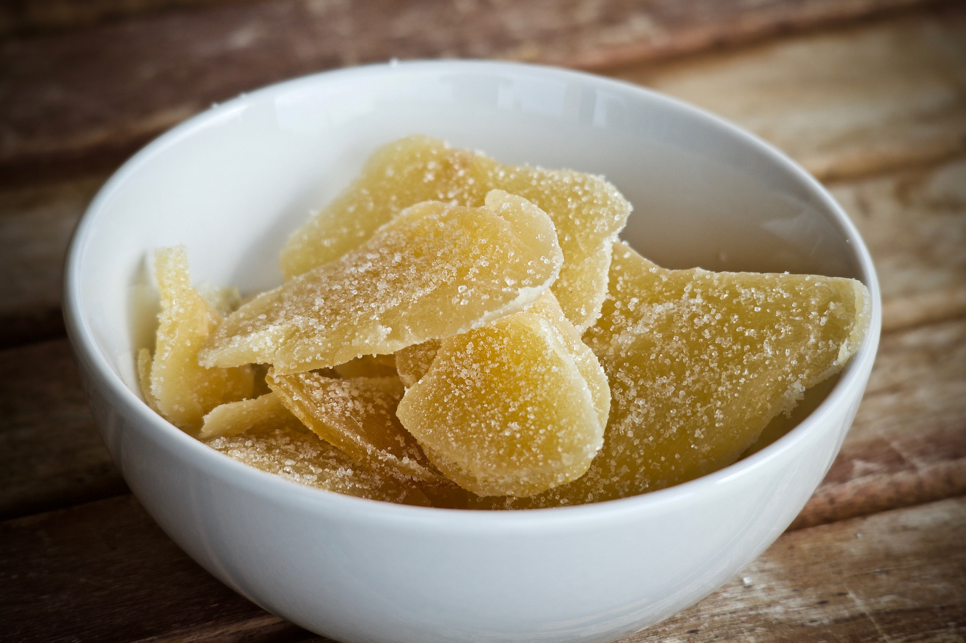 Dried ginger fruit in a white bowl.