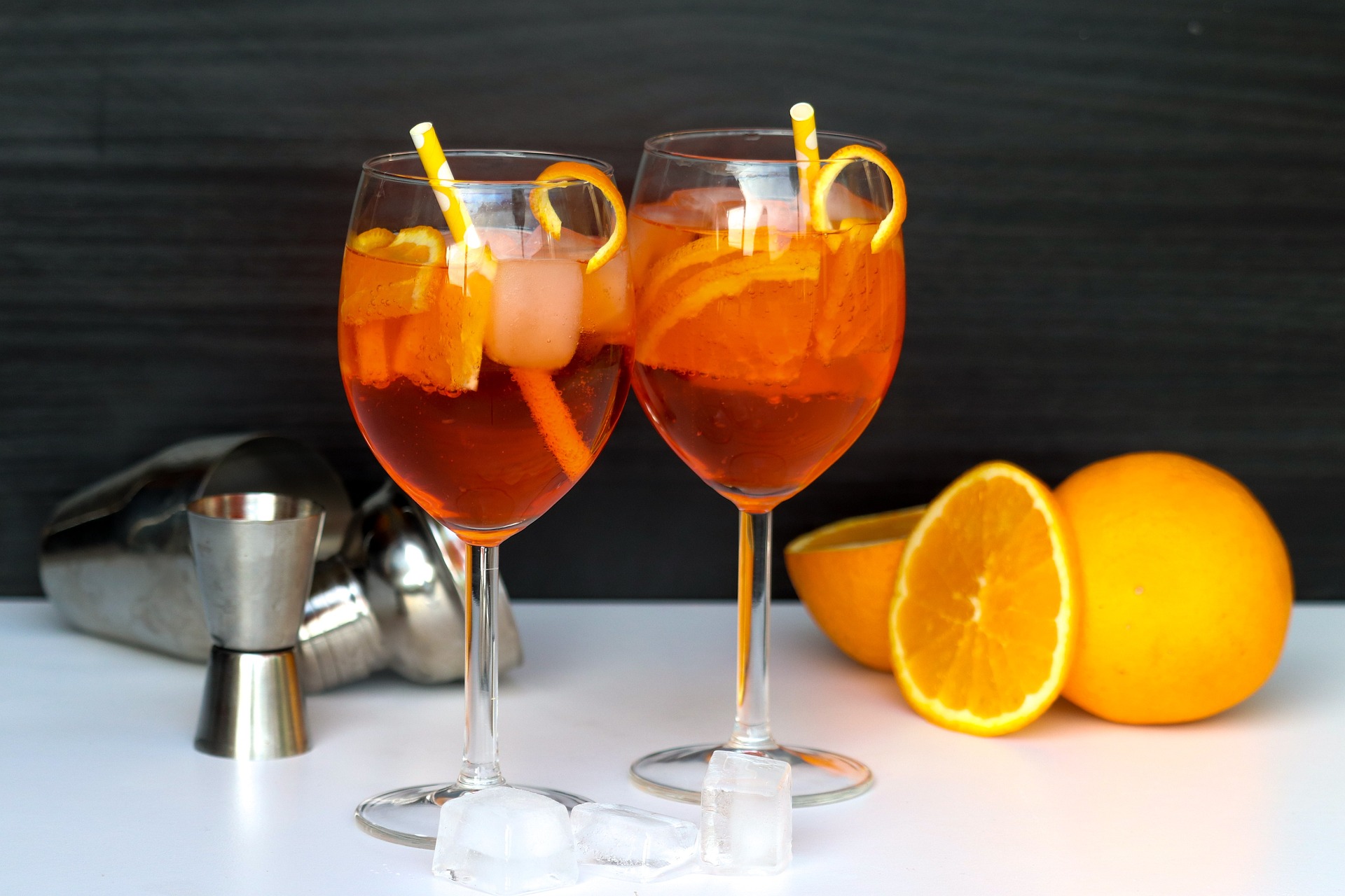 Two low-alcohol spritzers with fresh fruit and ice.