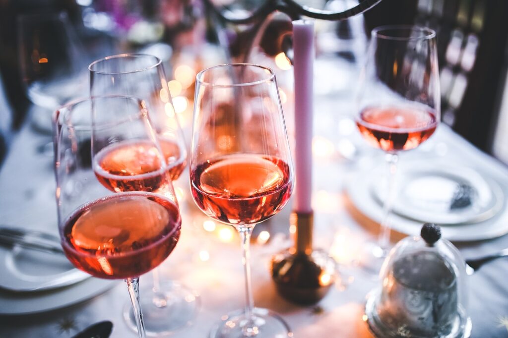 Three glasses of wine on a dinner table.