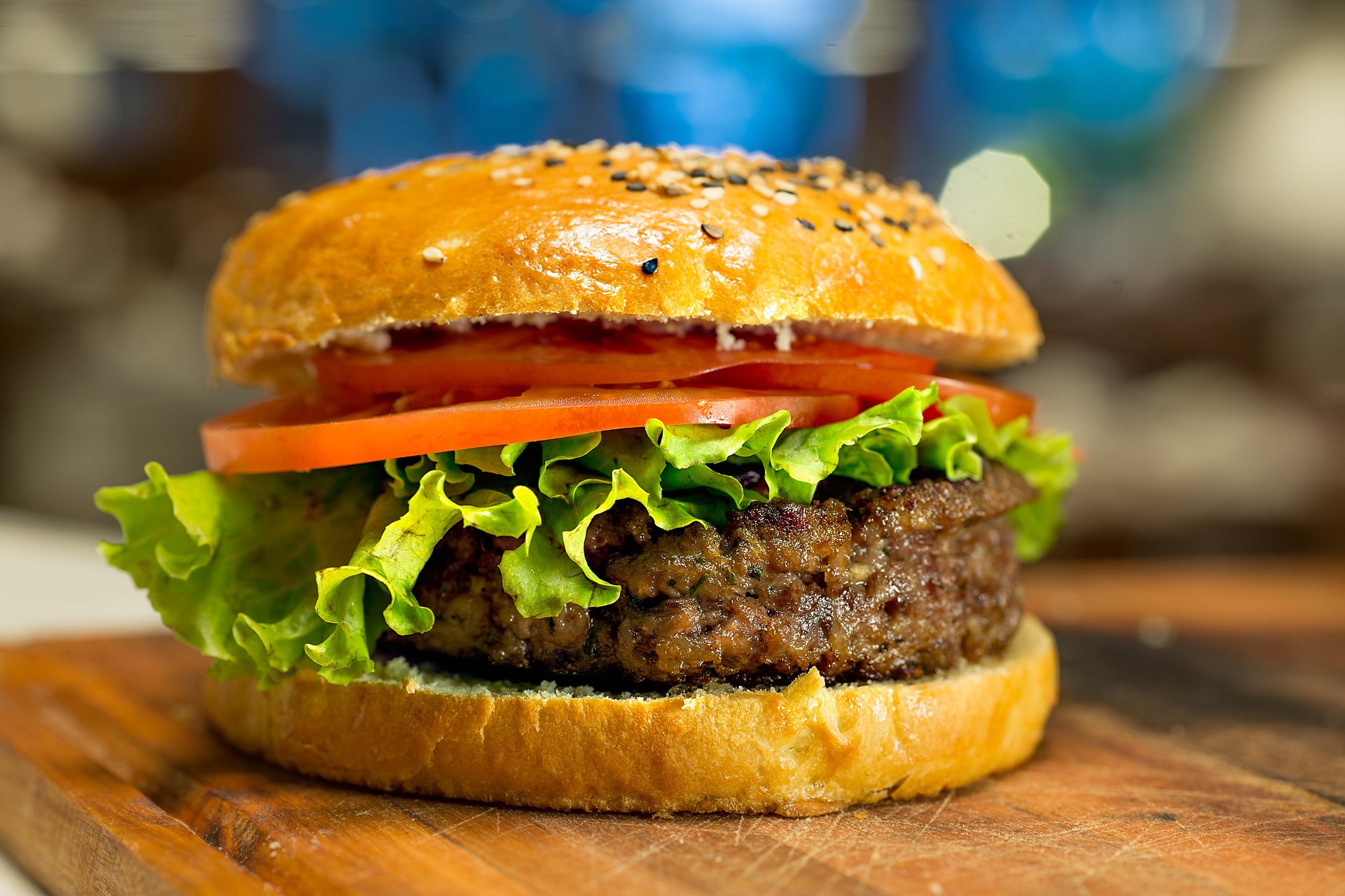 Gourmet veggie burger with lettuce and tomato on a cutting board