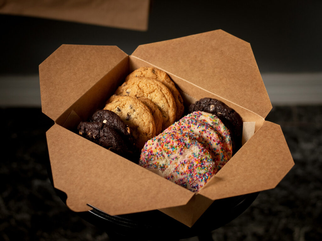 A variety of baked cookies in a box.