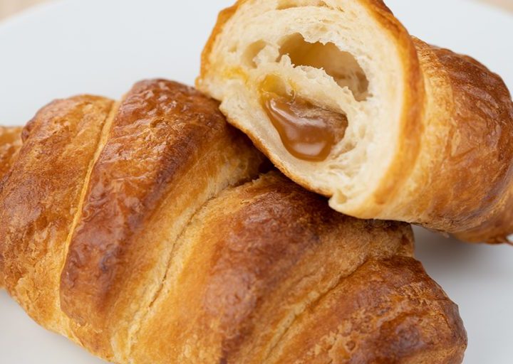  Two croissants with bake-stable fillings on a plate.