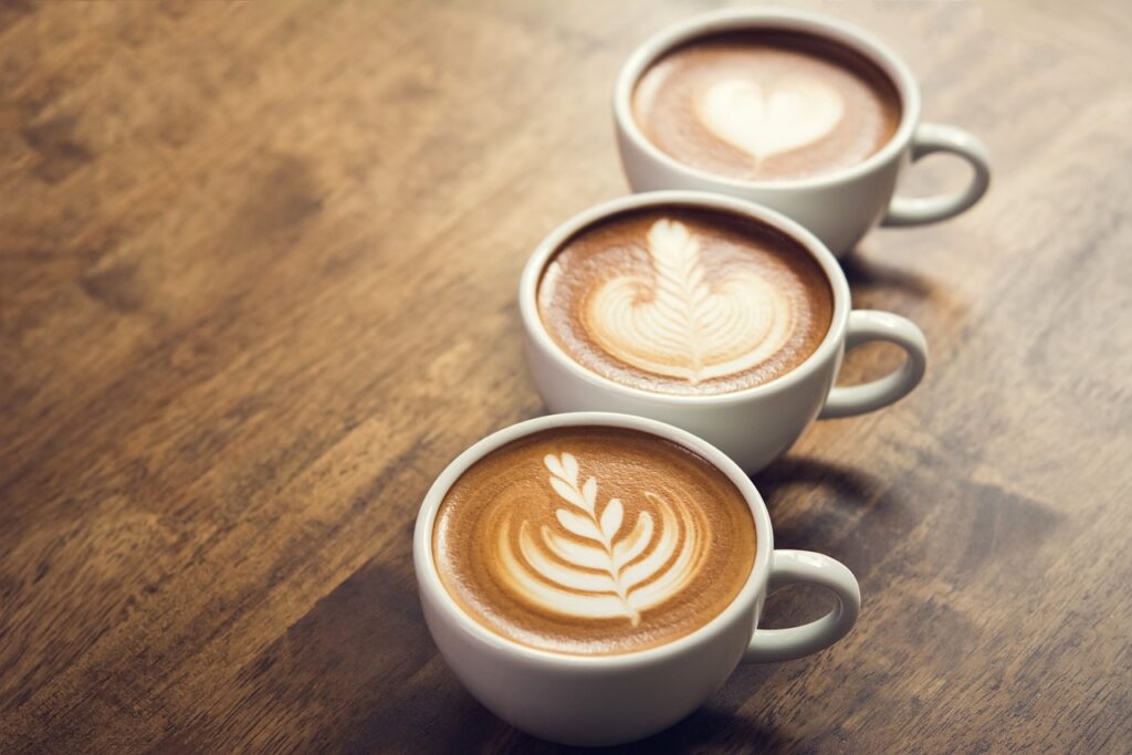 A close-up of three mugs of coffee on the table.